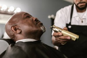 a man getting his beard trimmed - Dato Sri Darren Yaw